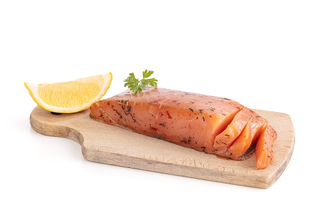 Artisanal smoked salmon on a cutting board  on white background