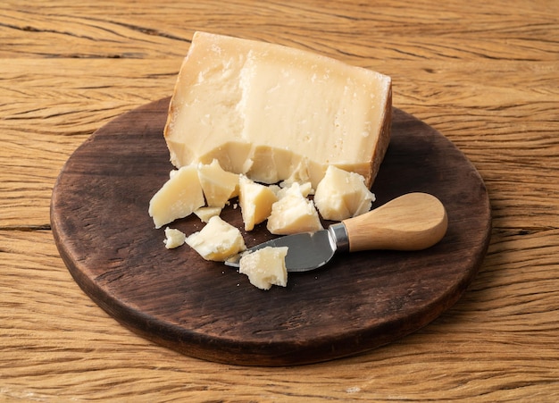 Artisanal Tulha cheese from Brazil with pieces over wooden table