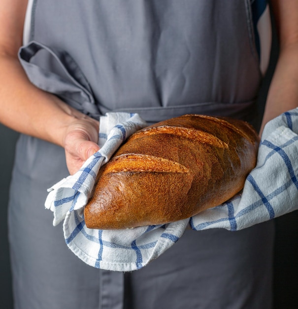 Artisanal wheat loaf in the hands of women