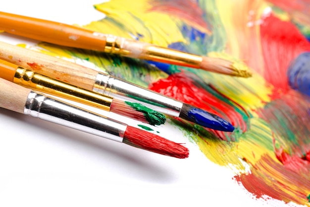 Artist brushes and paint on bright background