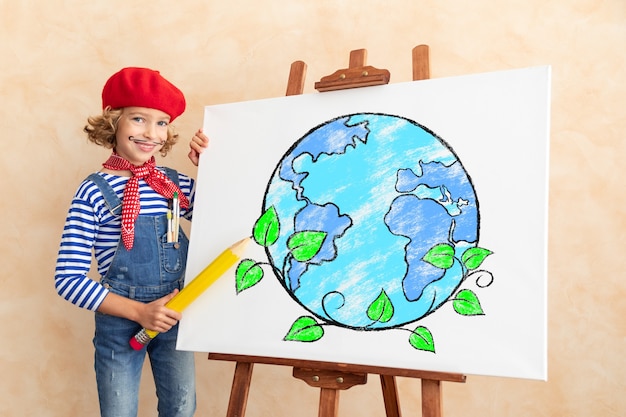 Artist child painting the picture on canvas.