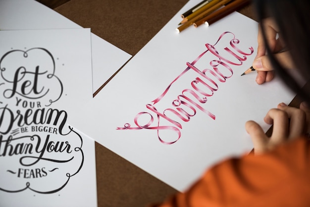 An artist creating hand lettering artwork