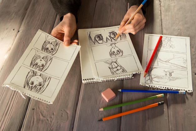 Artist drawing an anime comic book in a studio Wooden desk natural light Creativity and inspiration concept