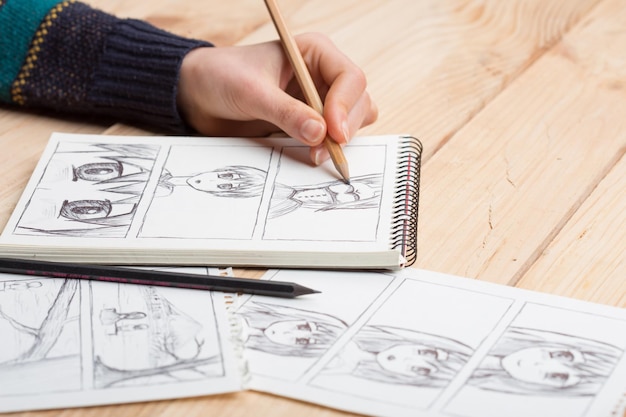 Photo artist drawing an anime comic book in a studio