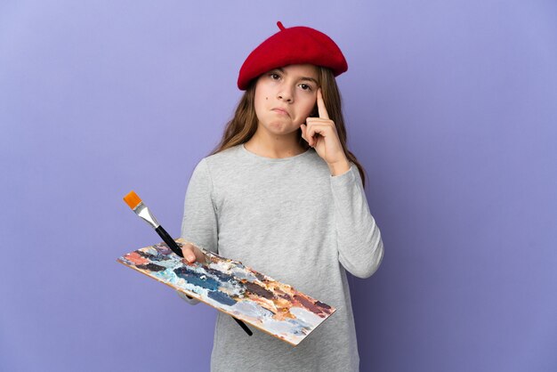 Artist girl over isolated background thinking an idea