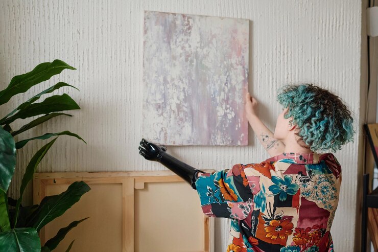 Photo artist hanging picture on wall