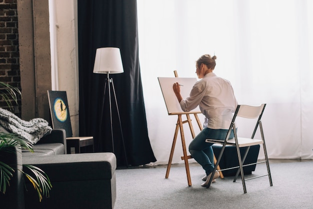 Photo artist painting in living room