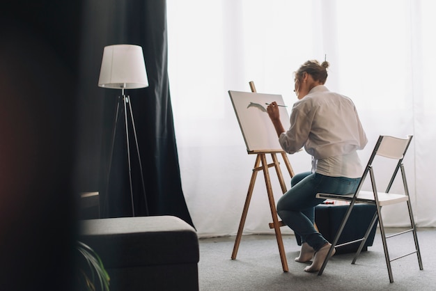 Photo artist painting in room