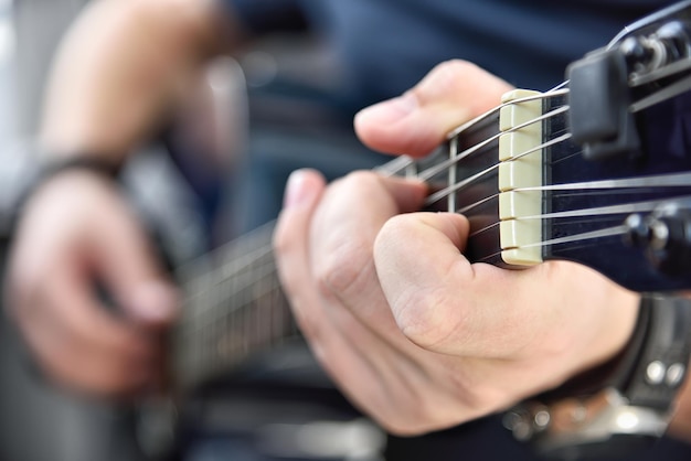 Artist playing on acoustic guitar