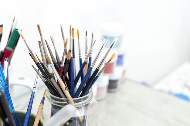 Artist's brushes in a Jar in a painting studio