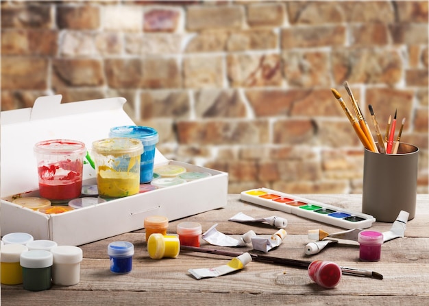 Photo artist's workshop. canvas, paint, brushes, palette knife lying on the table.