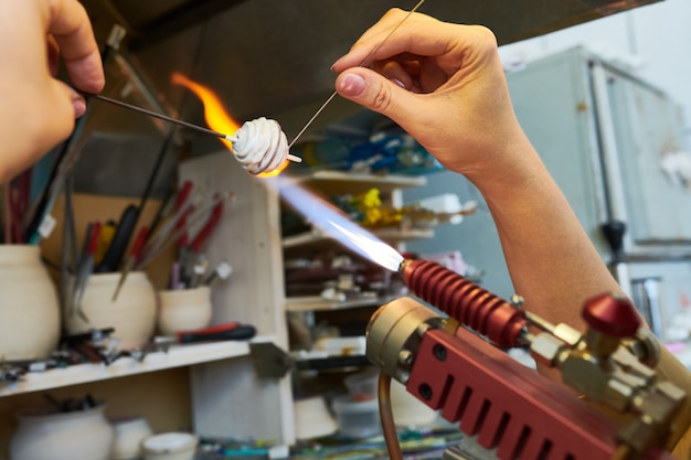 Artist Shaping Glass Beads in Flame