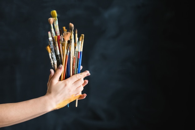 Artist supplies. Art lifestyle. Paintbrushes assortment in woman hands.