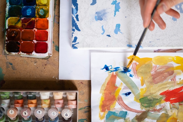 artist using watercolor to paint his art in the studio