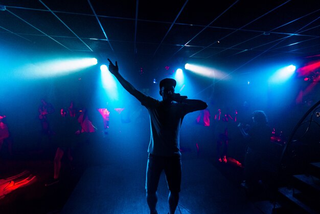 Artist with a microphone performs on the stage of a nightclub