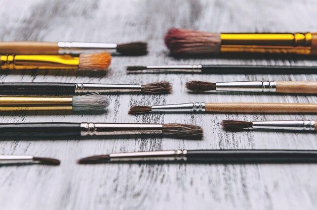 Artistic brushes on wooden surface