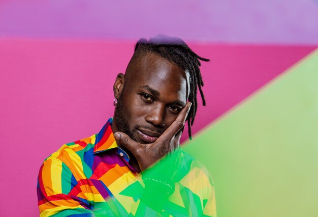 Artistic portrait with gel lights. handsome man posing on\
colored backgrounds