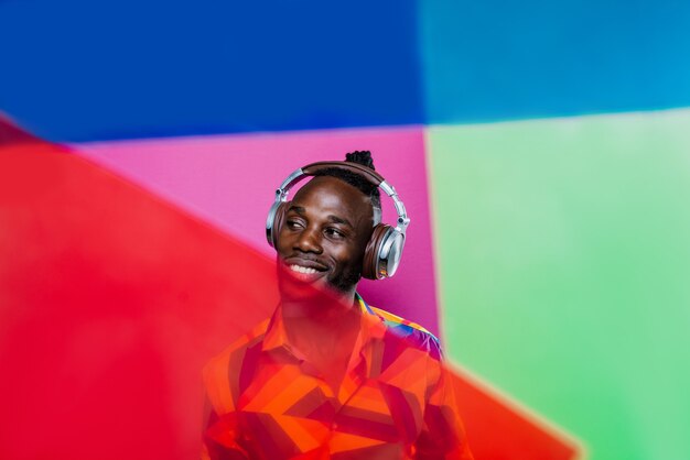 Artistic portrait with gel lights. Handsome man posing on colored backgrounds