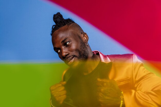 Artistic portrait with gel lights. Handsome man posing on colored backgrounds