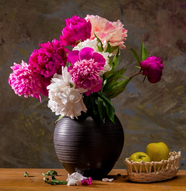 Artistic still life with peonies and apples