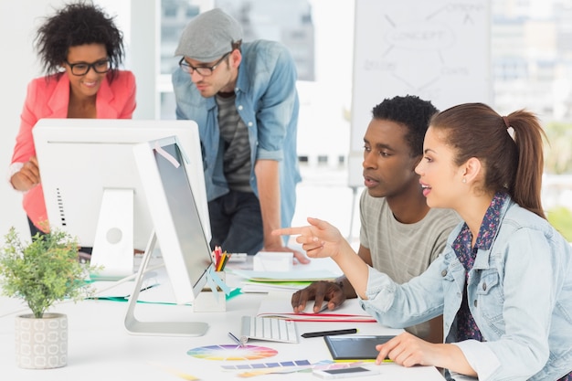 Artists working at desk in creative office