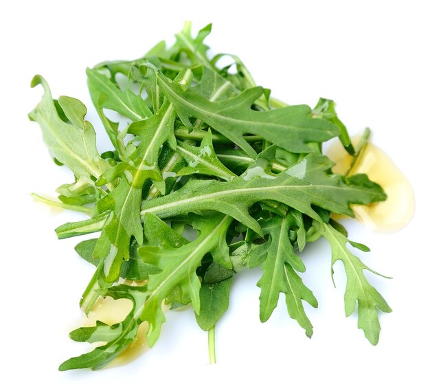 Arugula leaves salad with oil isolated on white