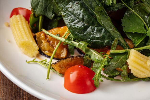 Arugula salad with shrimp on the wooden background