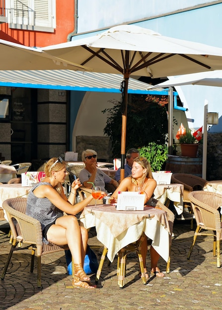 Ascona, Switzerland - August 23, 2016: People relaxing in Street Restaurant at Ascona town on Lake Maggiore in Ticino canton of Swiss.