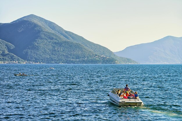 Ascona, Switzerland - August 23, 2016: People sailing in the boat at the luxurious resort in Ascona on Lake Maggiore in Ticino canton of Switzerland.