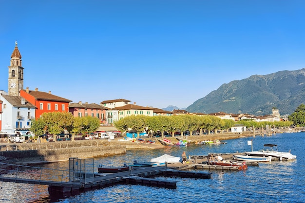 Ascona, Switzerland - August 23, 2016: St Peter and Paul church tower and colorful Swiss buildings at the luxurious resort in Ascona on Lake Maggiore, Ticino canton in Switzerland.