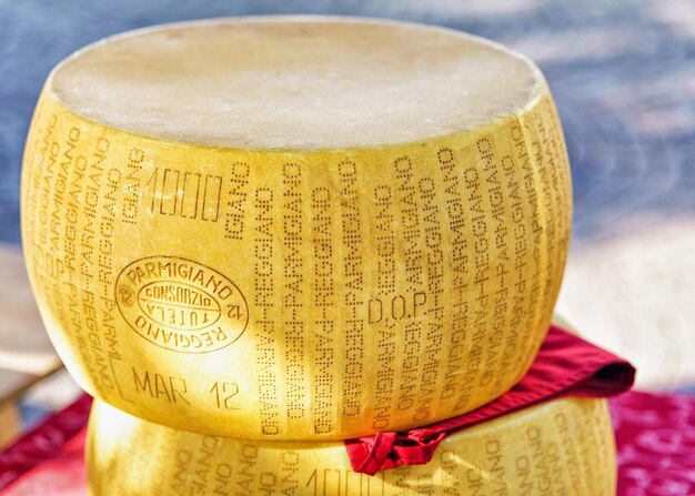 Ascona, Switzerland - August 23, 2016: Typical italian Parmigiano Reggiano cheese head on the counter in Ascona street market, Lake Maggiore, Ticino canton, in Switzerland.