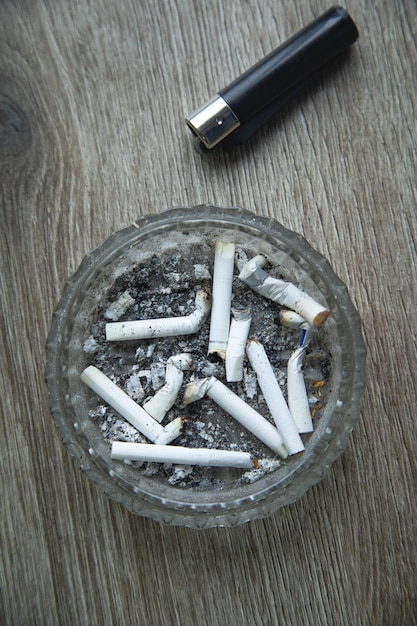 Ashtray cigarettes and lighter on the table