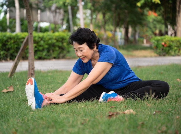 Asia senior woman training stretching at garden