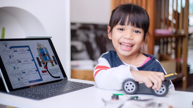 Asia students learn at home in coding robot cars and electronic\
board cables in stem steam mathematics engineering science\
technology computer code in robotics for kids concept