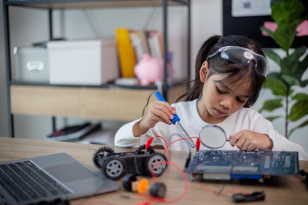 Asia students learn at home in coding robot cars and electronic board cables in STEM STEAM