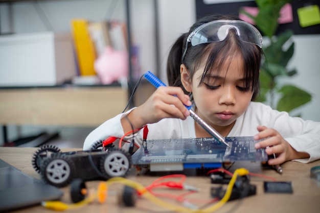 Asia students learn at home in coding robot cars and electronic board cables in STEM STEAM