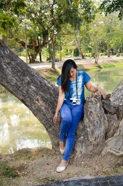 Asia thai woman travel visit and standing posing for take photo in public garden park in Sing Buri Thailand