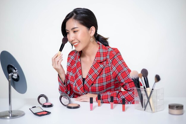 Asia woman beauty blogger does make up, reviews beauty product for video blog