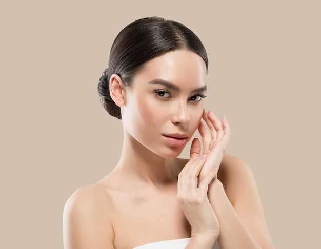 Asia woman beauty face body portrait touching her face healthy skin. Color background. Brown