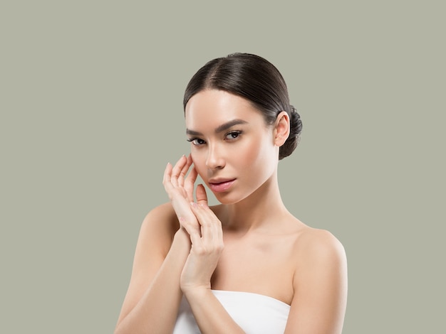 Asia woman beauty face body portrait touching her face healthy skin. Color background. Green