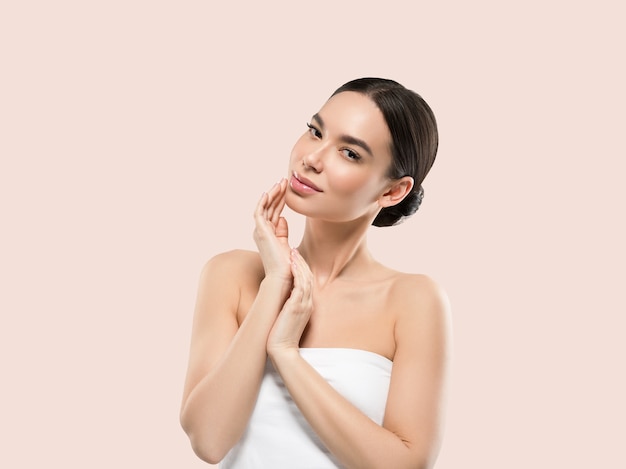 Asia woman beauty face body portrait touching her face healthy skin. Color background. Pink