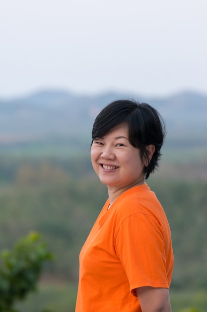 Asia woman posing and smile at mountain view