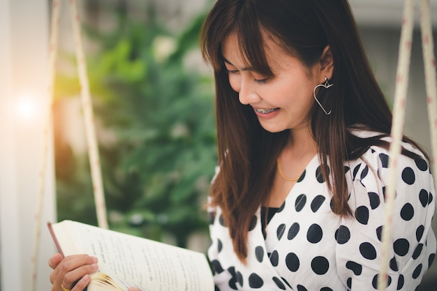 Asia woman reading book in free time with happiness