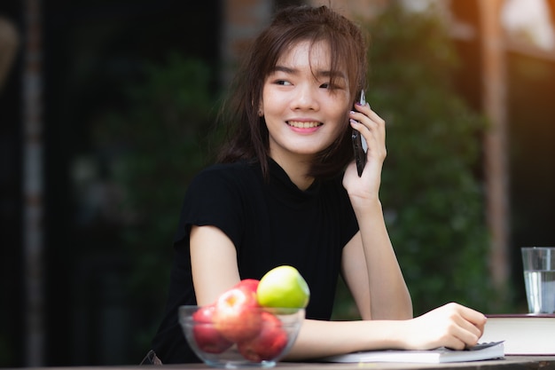 asia woman using smartphone with happy in free time.