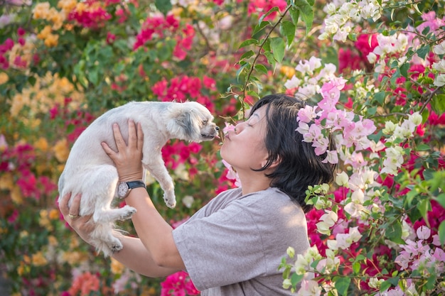 Asia women and dog happy smile kissing 