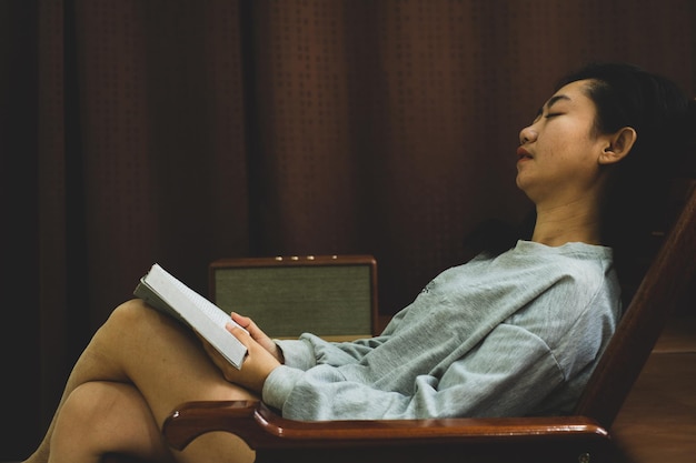 Asia women sitting and listening to music and sleeping in retro style living room