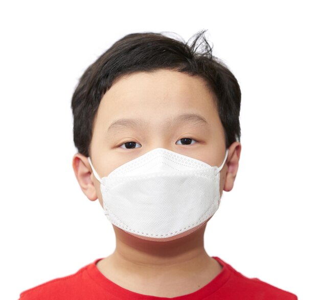 Asia young boy wear protect mask look at camera portrait isolated on white