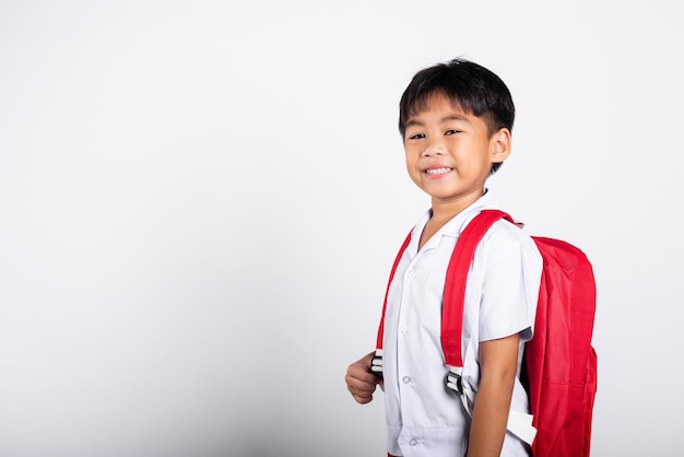 Asian adorable toddler smiling happy wearing student thai uniform standing