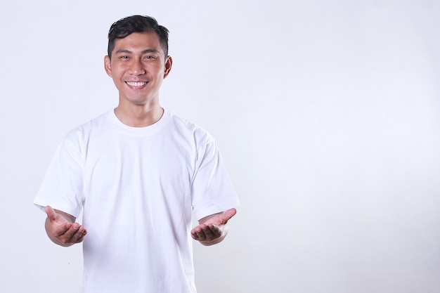 An Asian adult man wearing a white tshirt and showing his hands with a smiling face