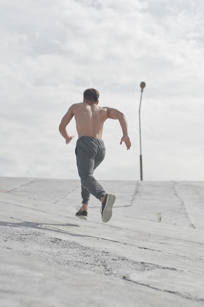 Asian athlete man jogging in the morning outdoors, Kazakh runner minimalism photo style